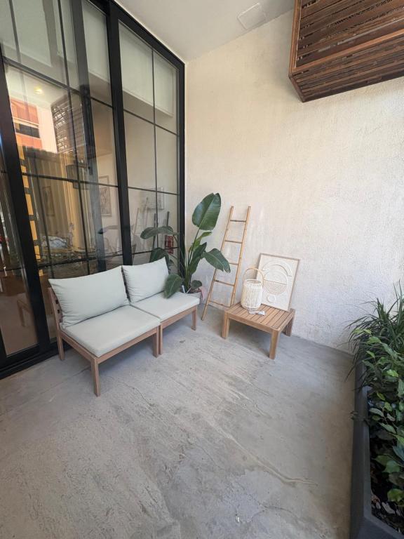 a patio with a couch and a table and a chair at Mestalla flats & Rut in Valencia