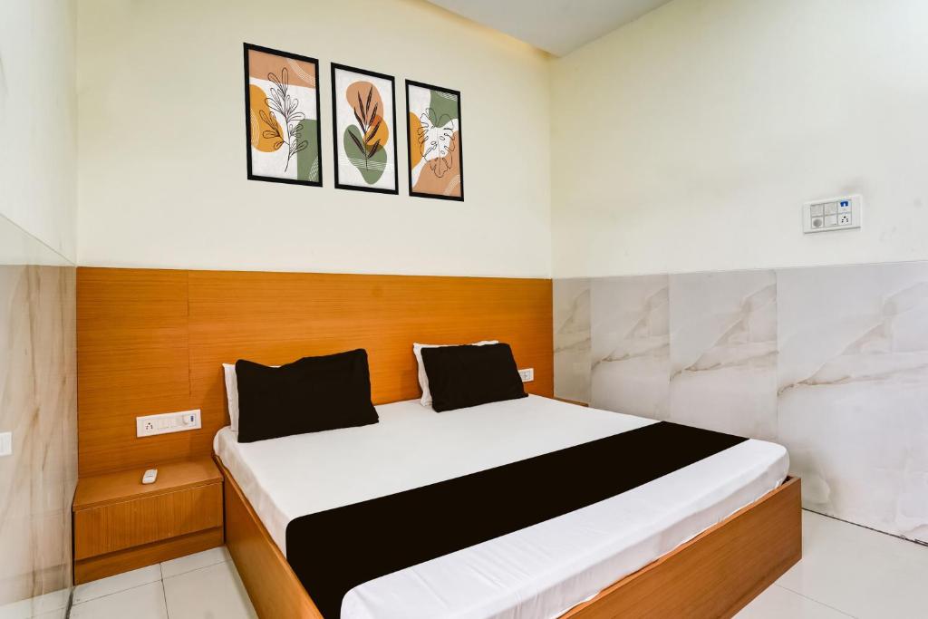 a bedroom with a large bed in a room at Hotel O Balaji Hotel & Banquet in Boisar