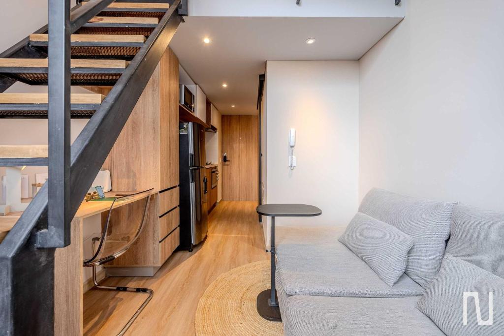 a living room with a couch and a staircase at NOK Luxury Studio in Chapinero in Bogotá