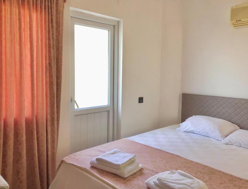 a bedroom with a bed with two towels on it at Deka apartments 5 in Fethiye