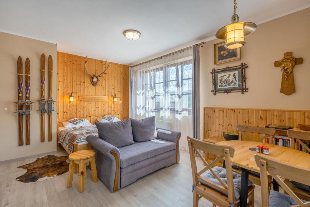 a living room with a couch and a table at Apartman Hubert in Kašperské Hory