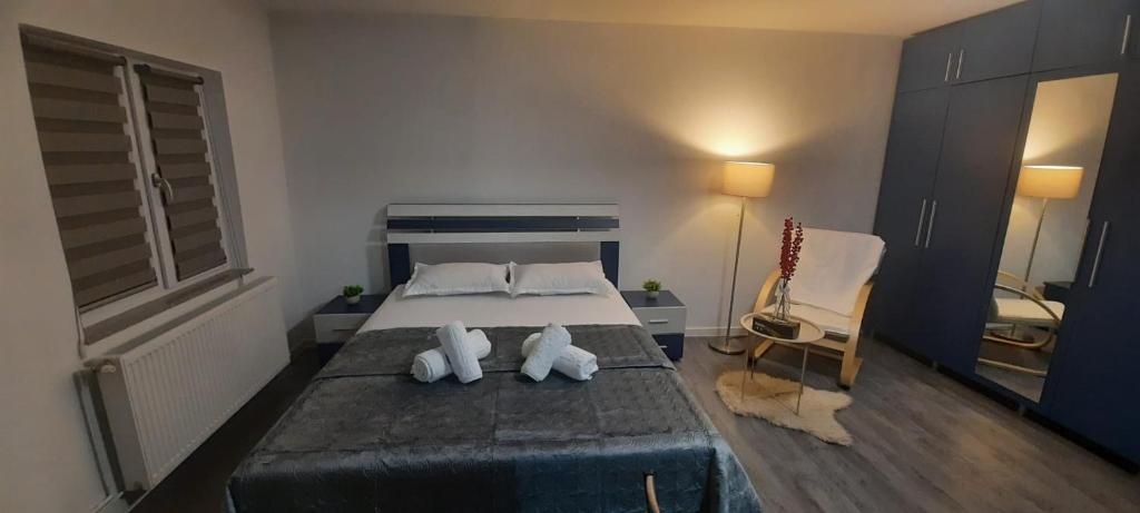 a bedroom with a bed with two stuffed animals on it at Garsoniera Mihaela in Craiova