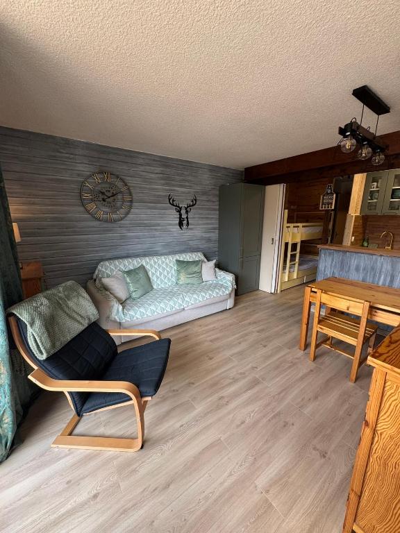 a living room with a couch and a table at Appt Rez-de-chaussée 4 pers in Orcières