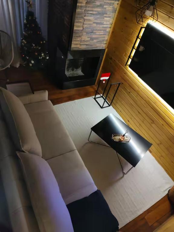 a living room with a couch and a christmas tree at Chalé cruzeiro do sul, hidromassagem, 2 min Thermas Machadinho-RS #1 in Machadinho