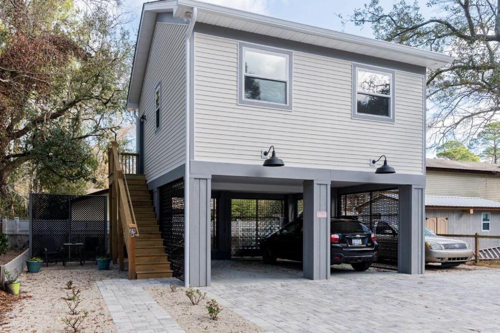 a house with a garage with a car in it at Charming Old Town Loft, nestled in the Heart of Historic Bluffton, SC in Bluffton