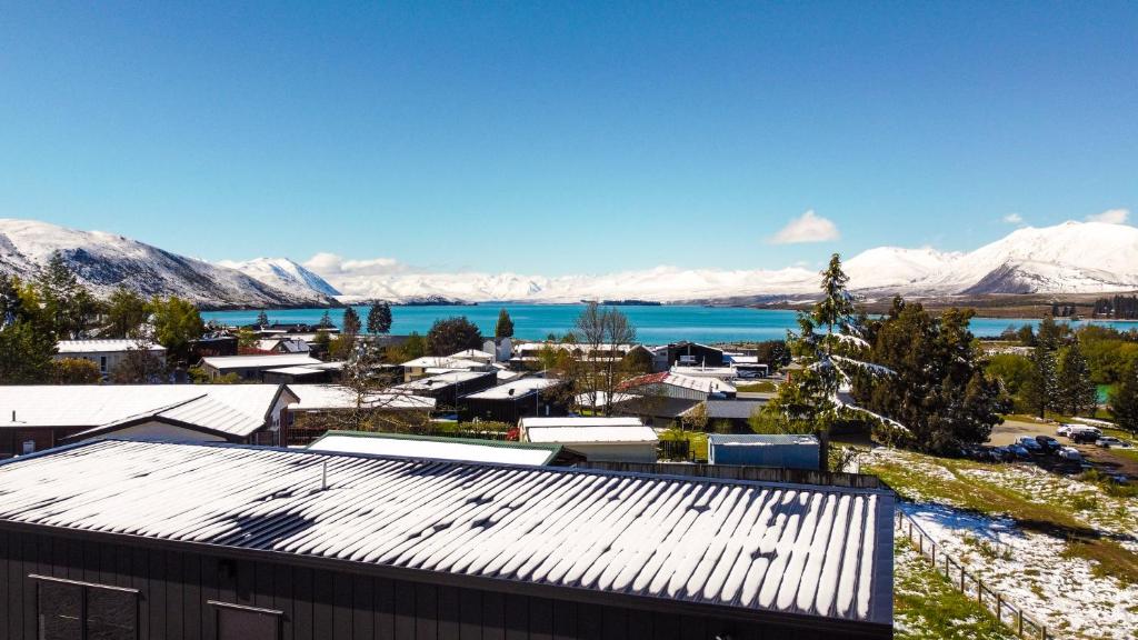 a view of a town with snow covered mountains at The Alpine 2-Bedroom Villa - Roam Lake Tekapo in Lake Tekapo