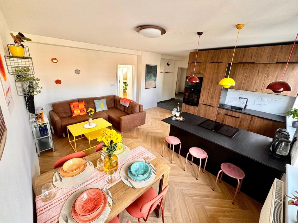 a living room and kitchen with a table and chairs at New flat close to center in Komárov