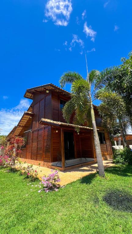 a house with a palm tree in front of it at Casa - Guarapari in Guarapari
