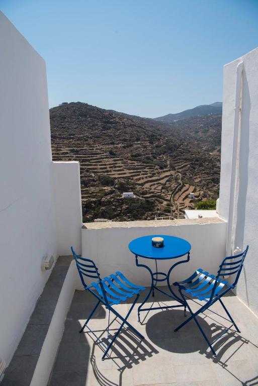 a blue table and chairs on a balcony with a view at eleni's cozy appartment in Kástron