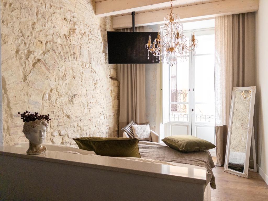 a room with a table with pillows on it at Cielo Cagliari For2 Design - Comfort Solo Adulti in Cagliari