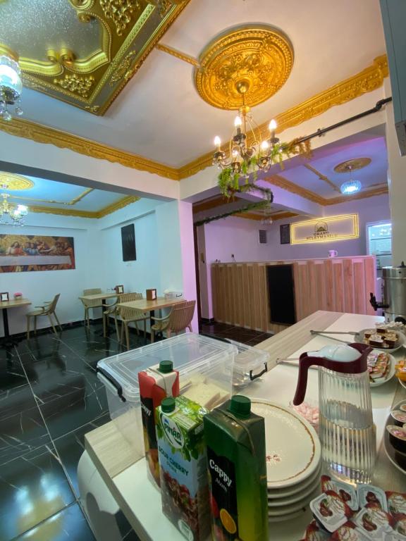 a restaurant with a counter with plates on it at Grand Süleymaniye Hotel in Istanbul