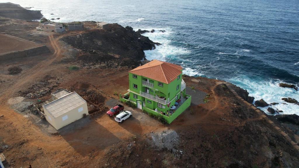 a house on a cliff next to the ocean at The edge of the Atlantic 