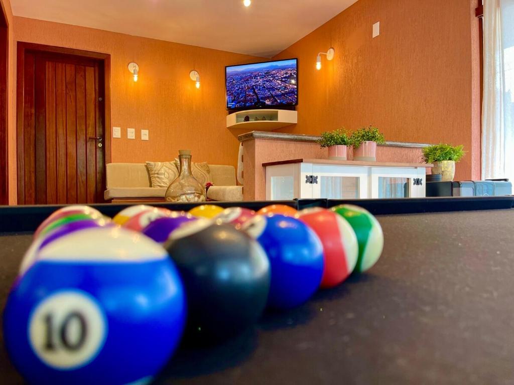 a row of pool balls on a table in a living room at Casa Arborizada - Bairro João Paulo Norte da ilha in Florianópolis