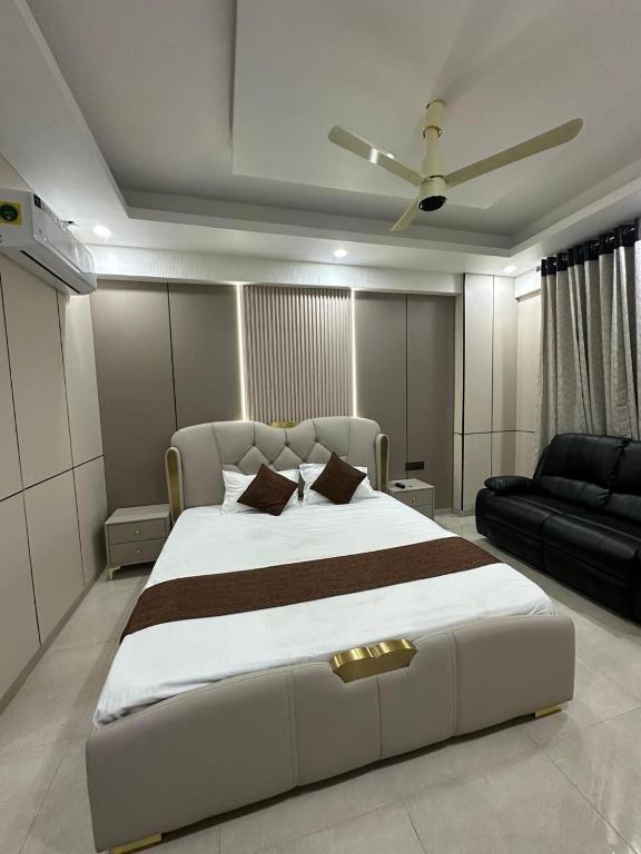 a bedroom with a large bed and a couch at Regal StayThe Perfect Blend of Luxury And Comfort in Nilmatha