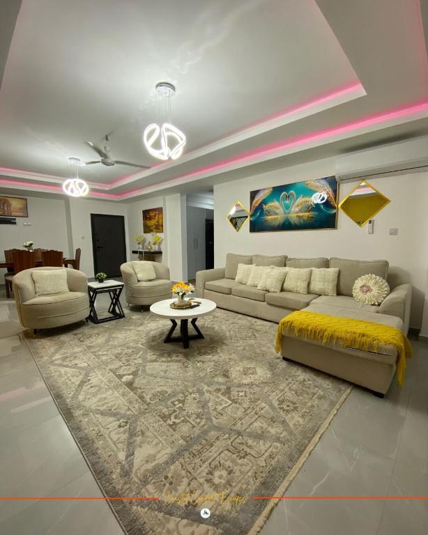 a living room with a couch and a table at Coastal Gem 3BR, Pool, 5 Min Walk to Beach - Nyali in Nyali