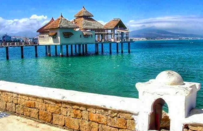 a house on a pier on a body of water at Appartement Mdiq in M'diq