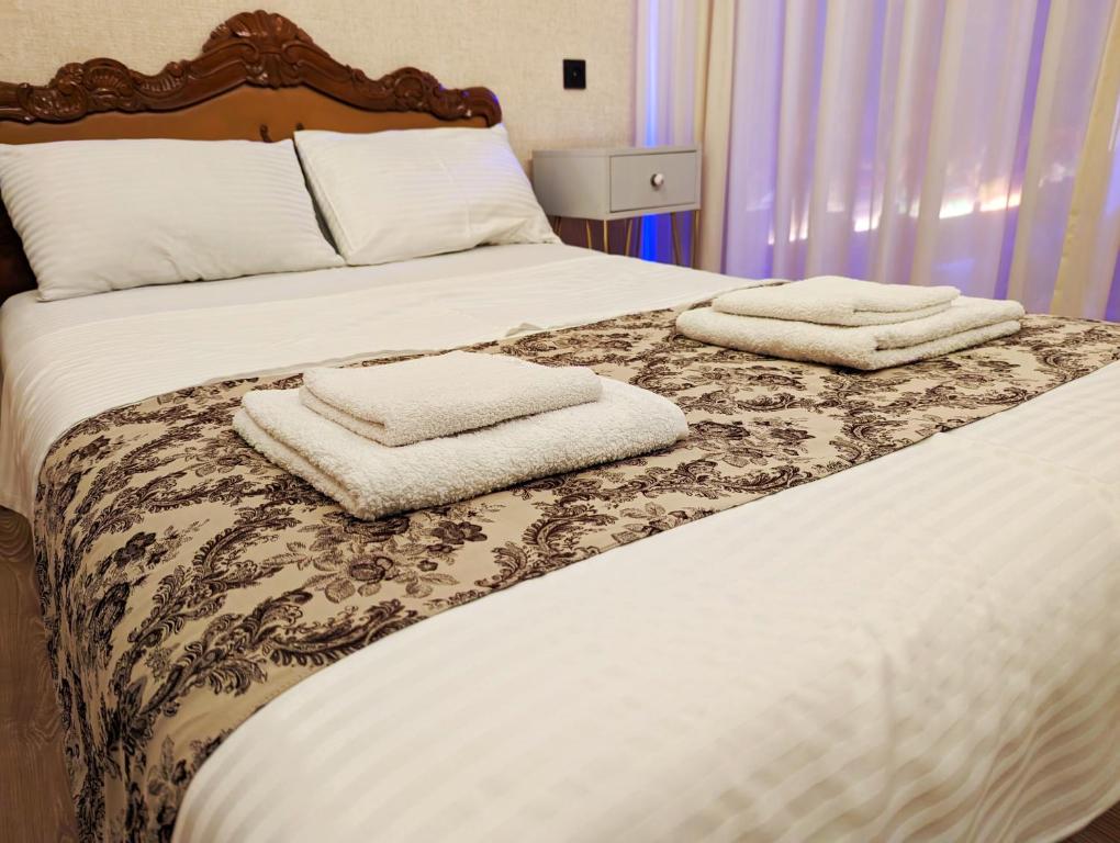 第比利斯Old Tbilisi style Apartment的卧室里有一张床，床上放着两条毛巾。