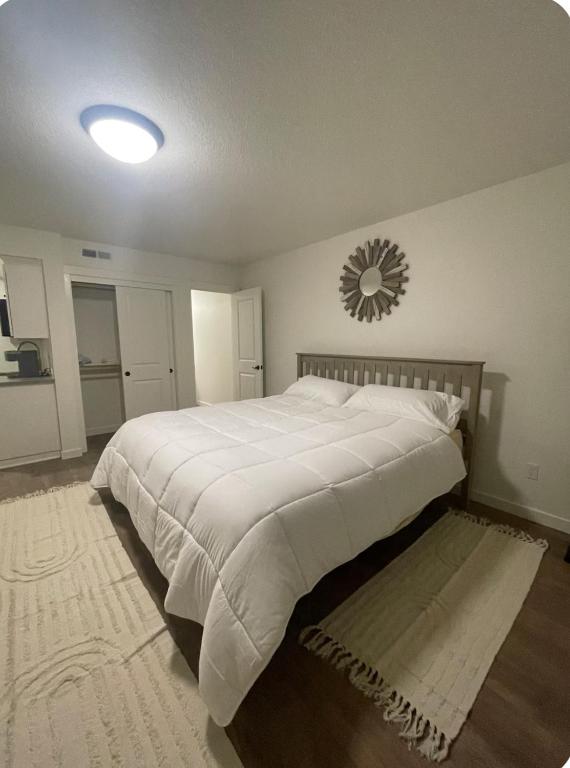 a bedroom with a large bed and a mirror on the wall at Home at Kingwood in Forest Grove in Forest Grove