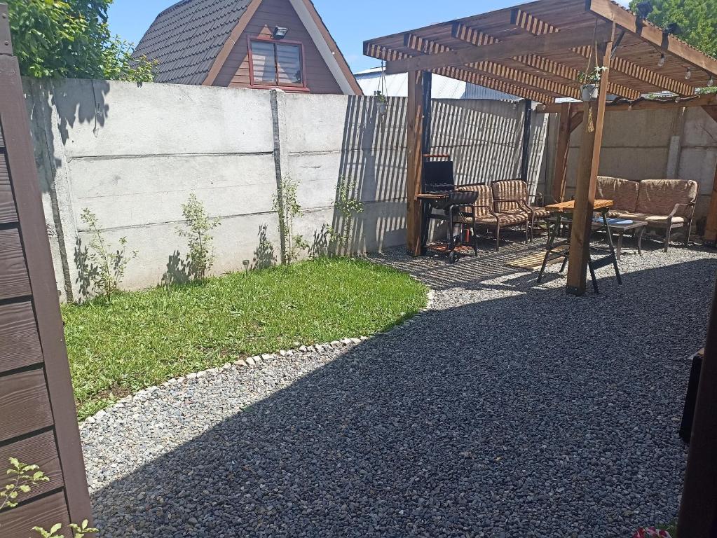 een achtertuin met een tafel en een hek bij Casa en barrio tranquilo in Osorno