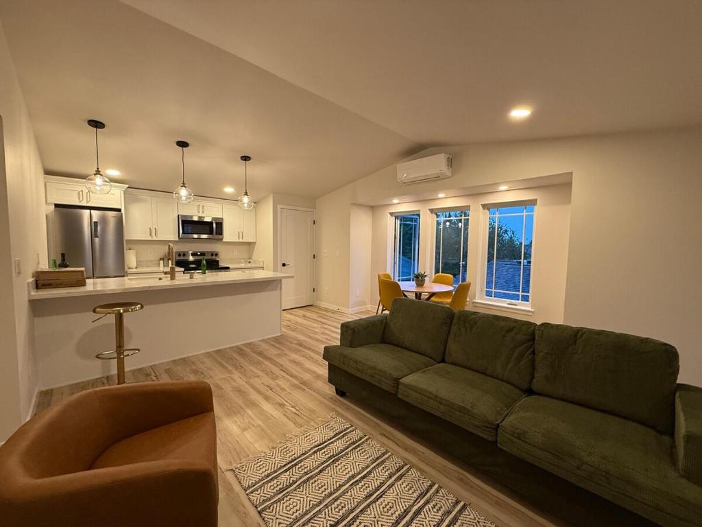 a living room with a couch and a kitchen at North Slope Nest in Tacoma