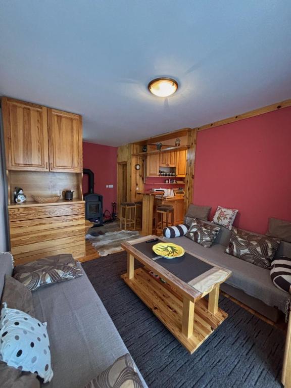 a living room with a couch and a table at Apartman Savic Jahorina in Jahorina