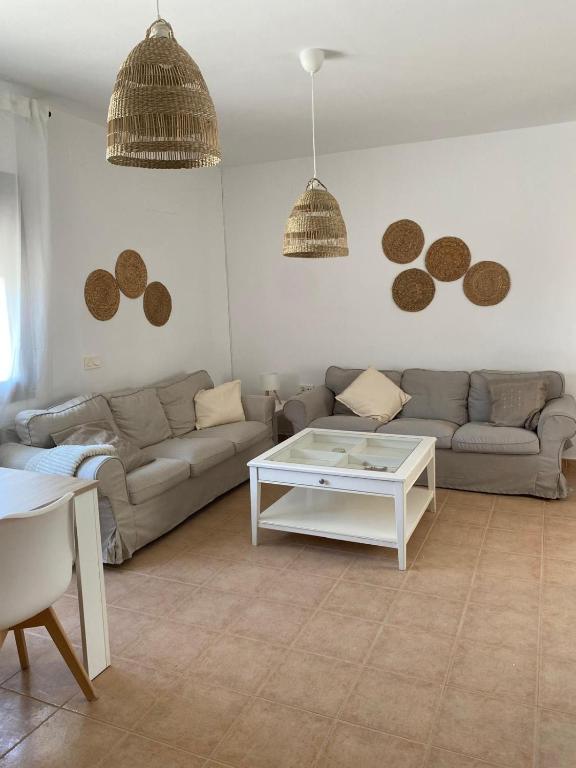 a living room with a couch and a table at Casa rural El Yelmo in Miguel Esteban