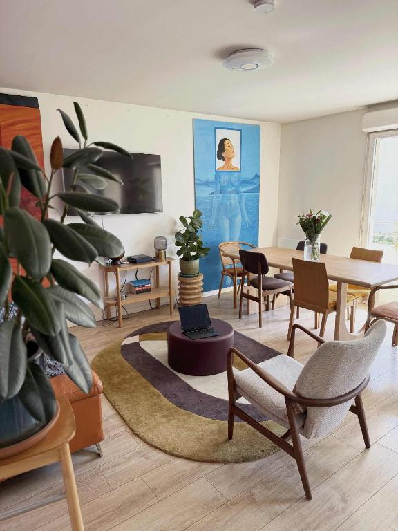 a living room with a table and chairs at uta house la plaine in Saint-Denis