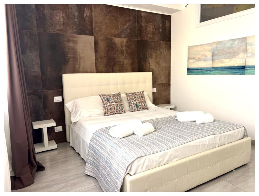 a bedroom with a bed with two towels on it at Anfitrite Suite Room in Pozzallo