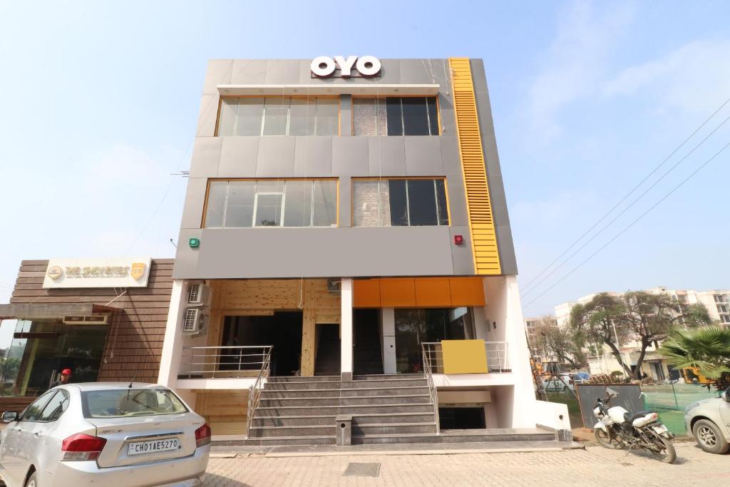 a building with a car parked in front of it at Hotel O Platina in Mubārikpur
