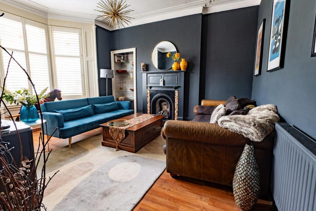 a living room with a couch and a fireplace at Traditional apt close to city centre & Hampden in Glasgow