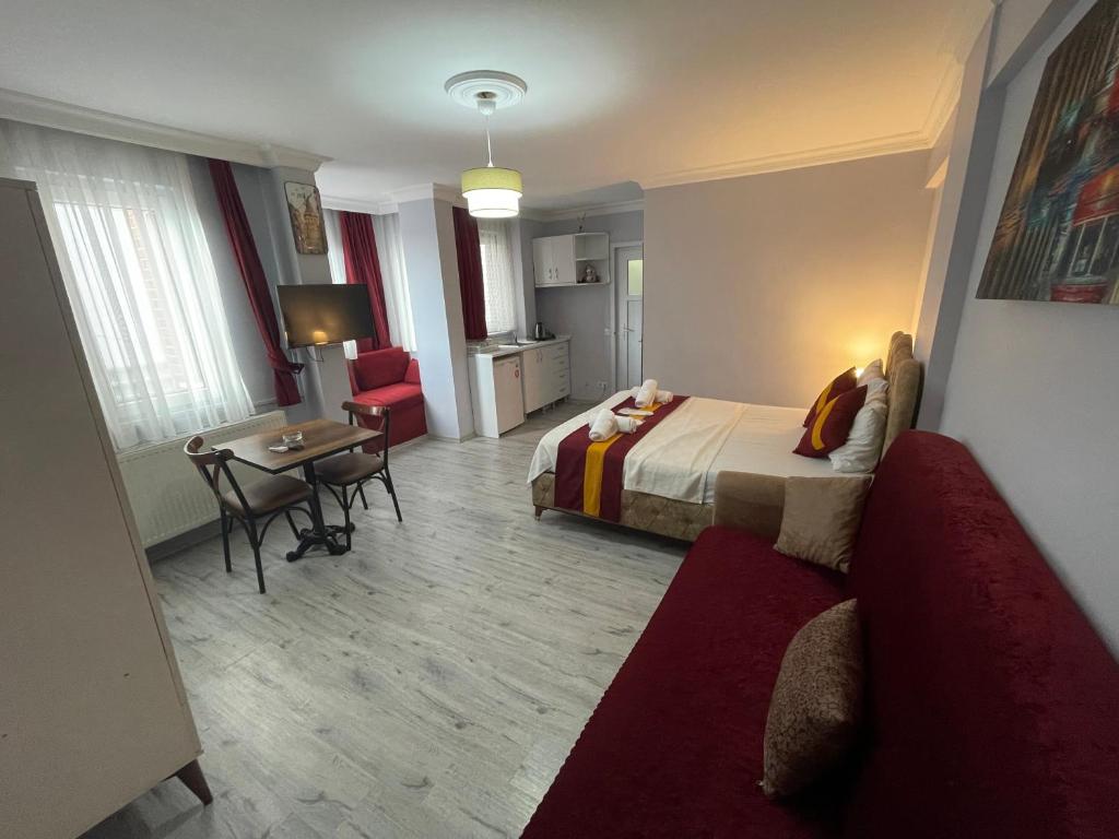 a hotel room with a bed and a table and a couch at Taksim Rain Suite in Istanbul