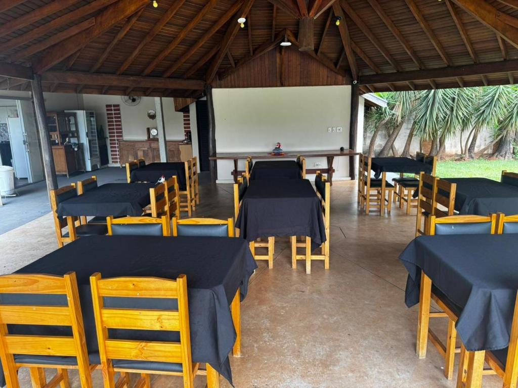 a restaurant with blue tables and chairs and a whiteboard at Hotel Fazenda Haras RD in Olímpia