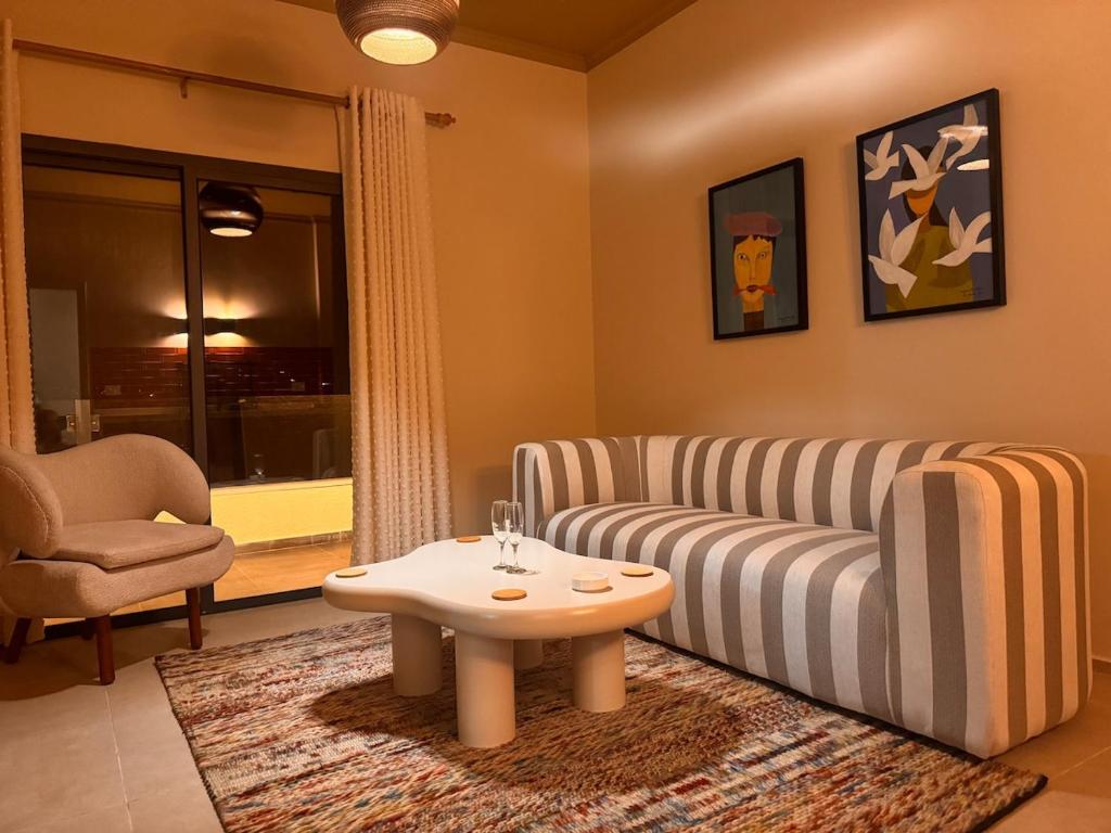 a living room with a couch and a coffee table at 603 Apartments in Baddah