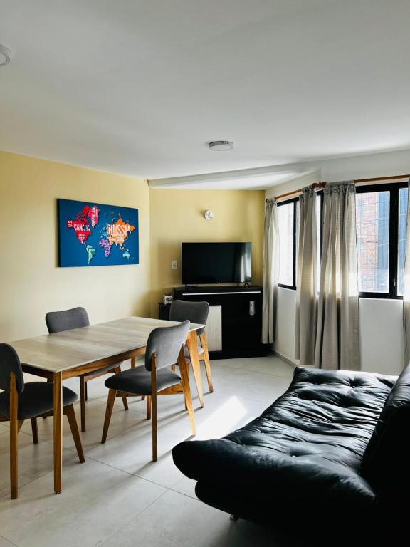 a living room with a table and chairs and a couch at Downtown rental in Río Grande