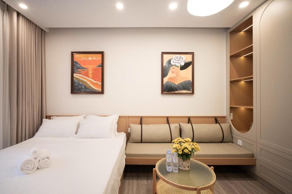 a hotel room with a bed and a couch at La Vie Eco in HÆ°ng YÃªn