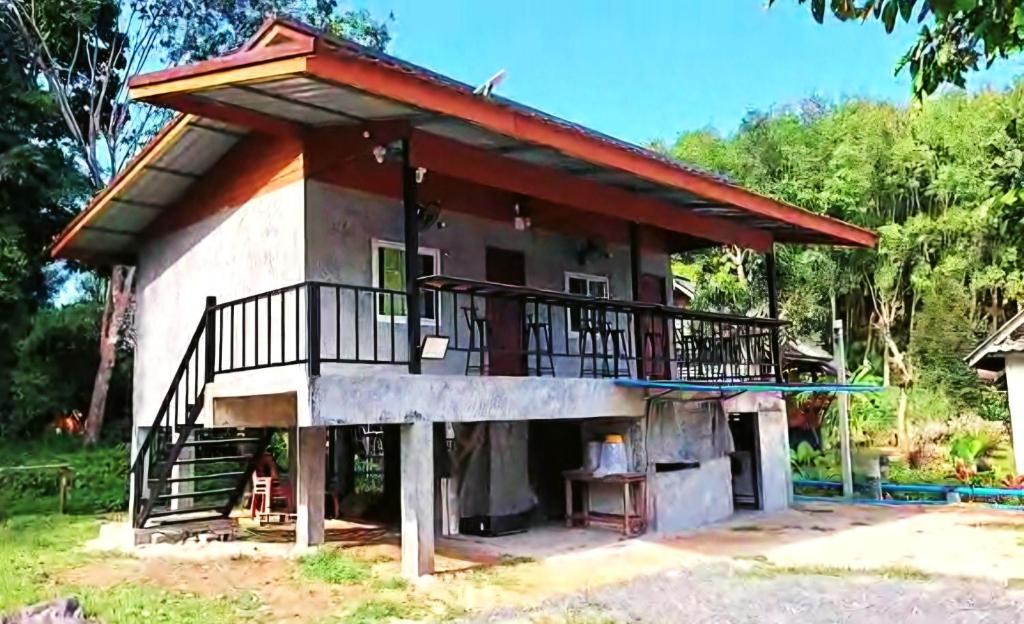 a small house with a balcony on top of it at Yao Noi Hostel by KR in Ko Yao Noi