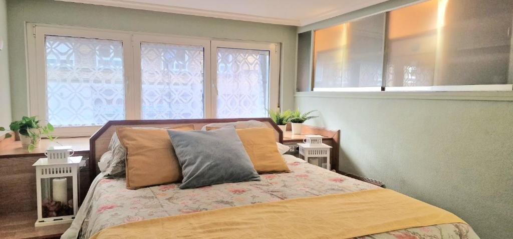 a bedroom with a bed with two pillows on it at La Cámara de El Cristo in Oviedo