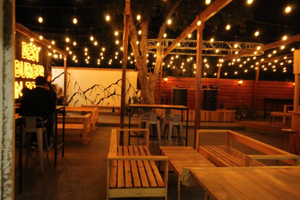 a person sitting at a table in a restaurant with lights at TIlcara Rooms in Tilcara