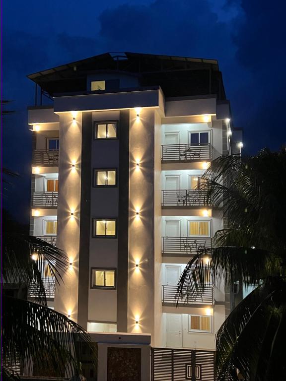 a tall building with lights on it at night at Luxury GuestHouse Suites in Cap-Haïtien