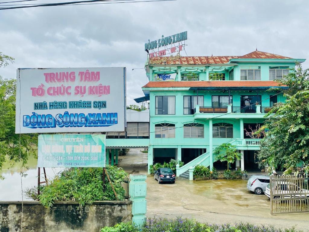a large building with signs in front of it at Khách sạn Dòng Sông Xanh in Thái Nguyên