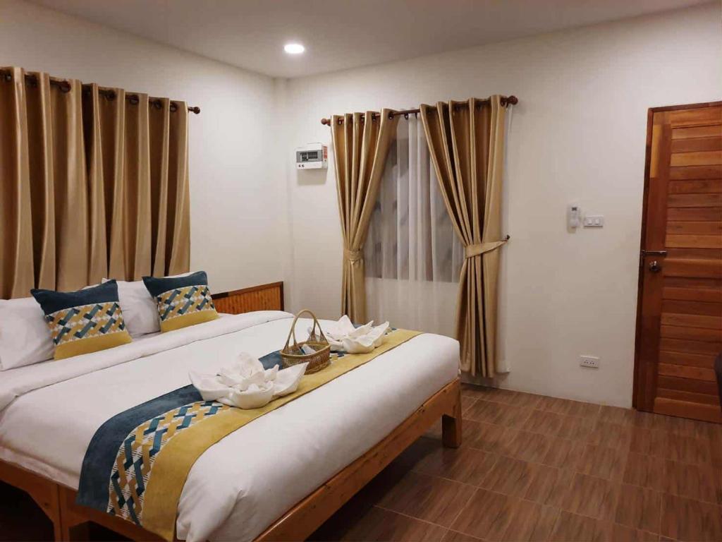 a bedroom with two beds with flowers on them at Pai Pavilion in Pai