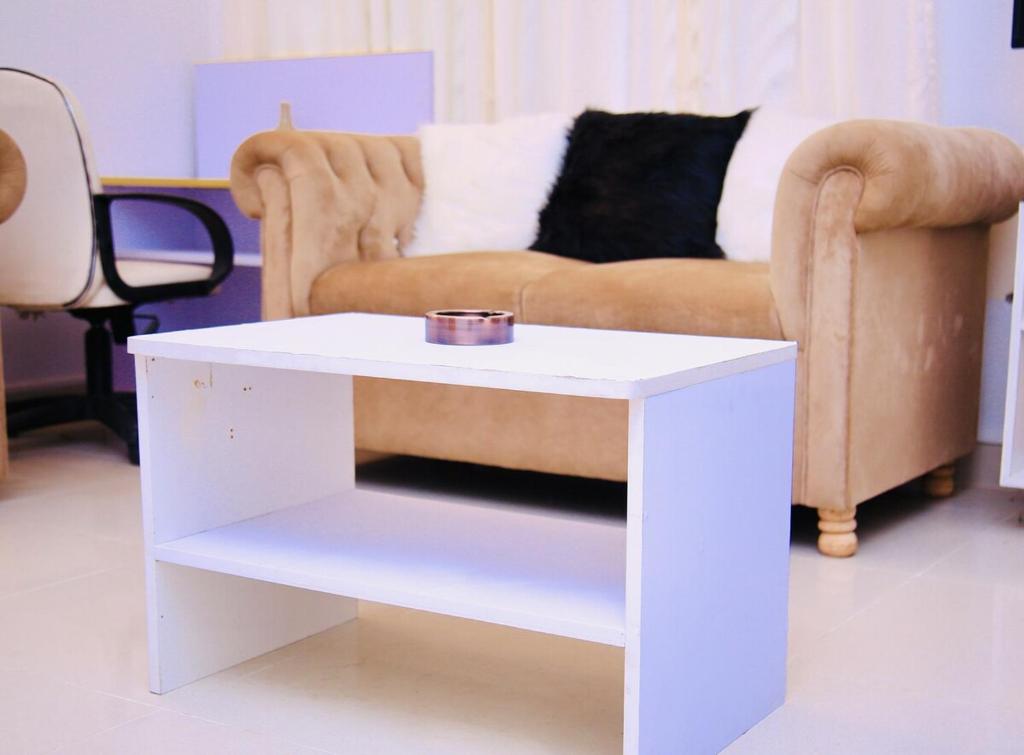 a white coffee table in a living room with a couch at 4BR Apt I 2 King SIZE BED I 2 Queen Size bed I Dhanmondi & Crescent Lake, Dhaka in Dhaka