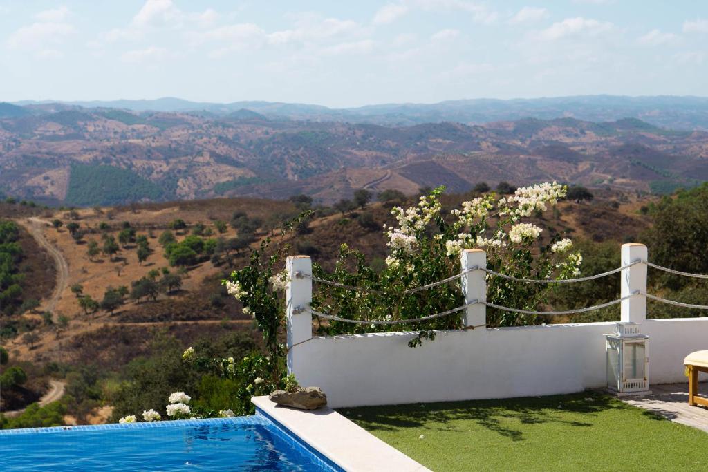 a swimming pool with a view of the mountains at Varandas do Vale Furnazinhas in Castro Marim