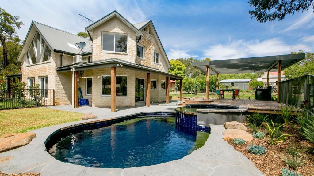 a swimming pool in the yard of a house at 2 Marma Retreat - Peaceful Surrounds with Heated Pool & Spa in Red Hill