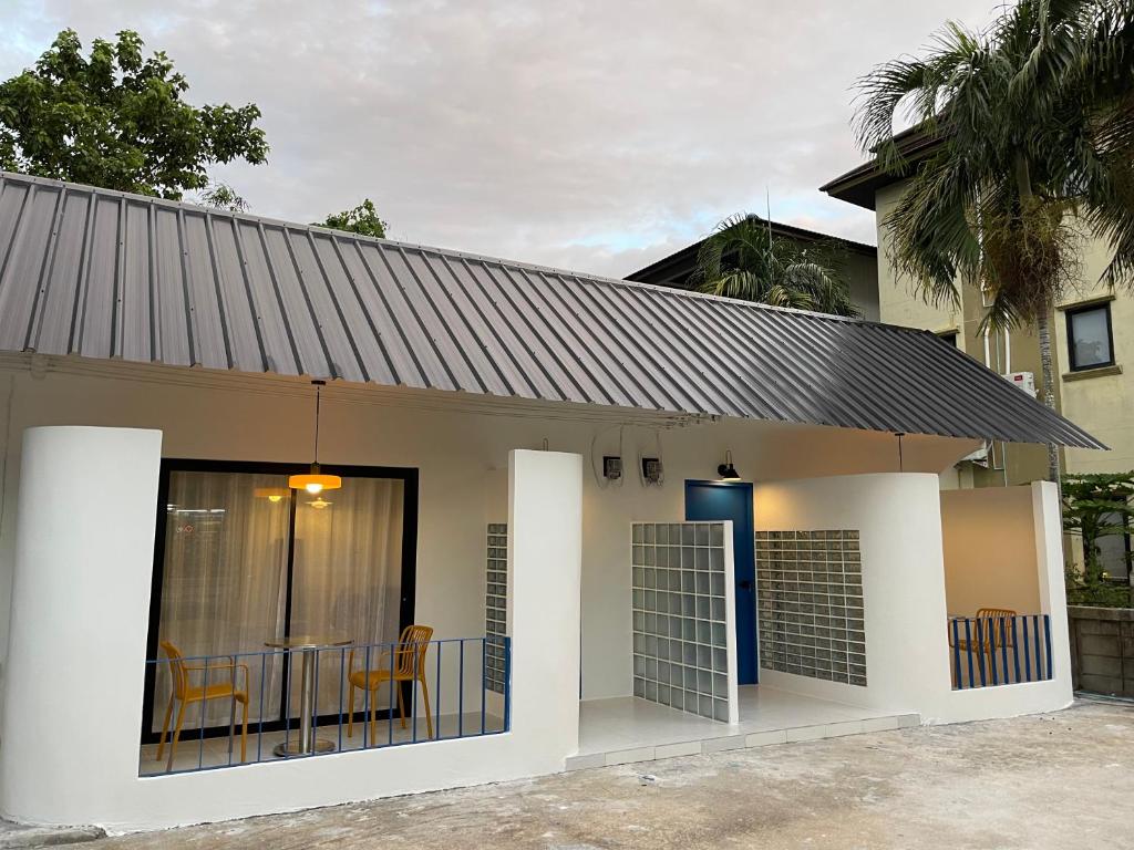 a small house with a gate and a balcony at The Lamoon Residence samui in Lamai