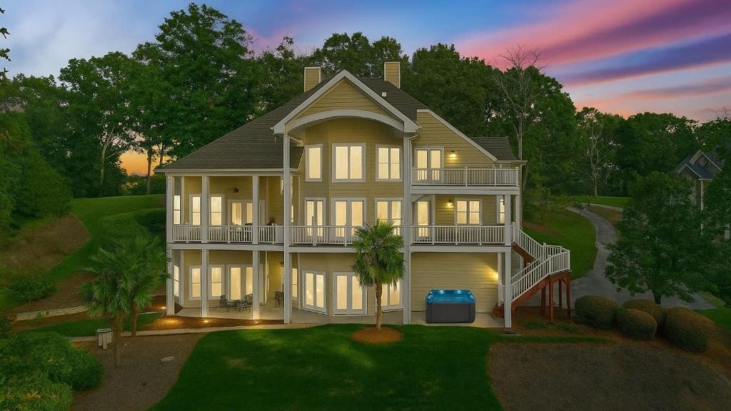 a large white house with a porch at Lakefront 6BDR Priv Dock Game Room Firepit Jakes Lake House by Avantstay in Westport