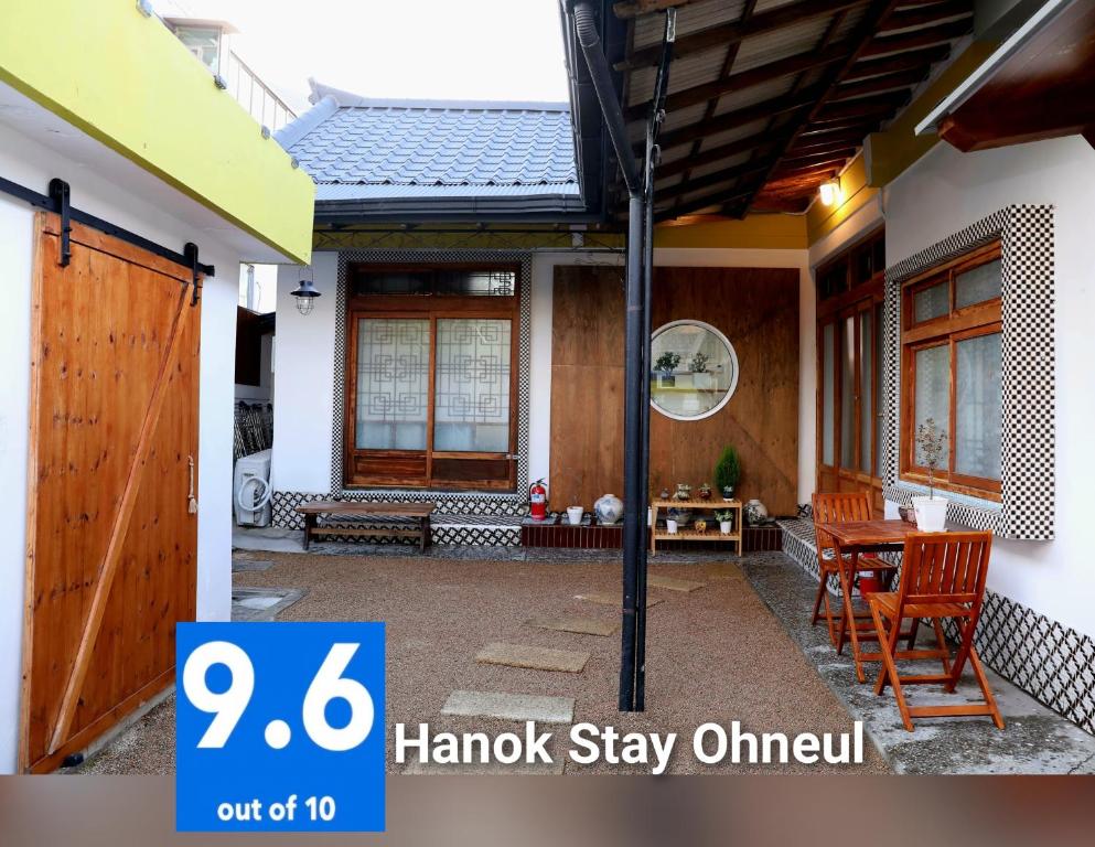 a front porch of a house with a table at Hanok Stay Ohneul in Gyeongju
