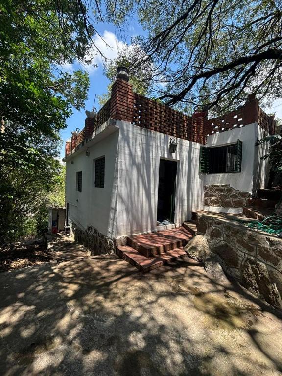 a white building with a staircase in front of it at Refugio Blue Hill in Villa Cerro Azul