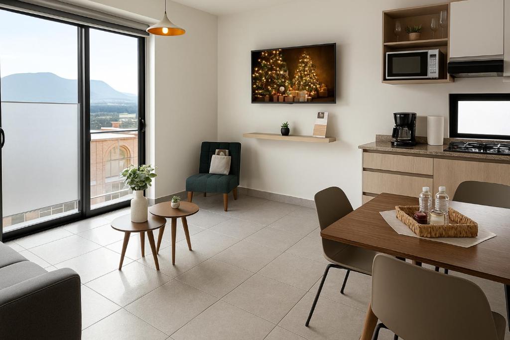 a living room with a table and a kitchen with a view at Departamento 3er Nivel ideal para turismo in Atlixco