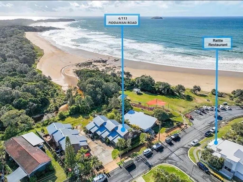 an aerial view of a beach with houses and the ocean at Emerald Break- The Perfect Coastal Escape in Emerald Beach